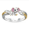 Ring with a small elephant design and pink gemstones on a white background