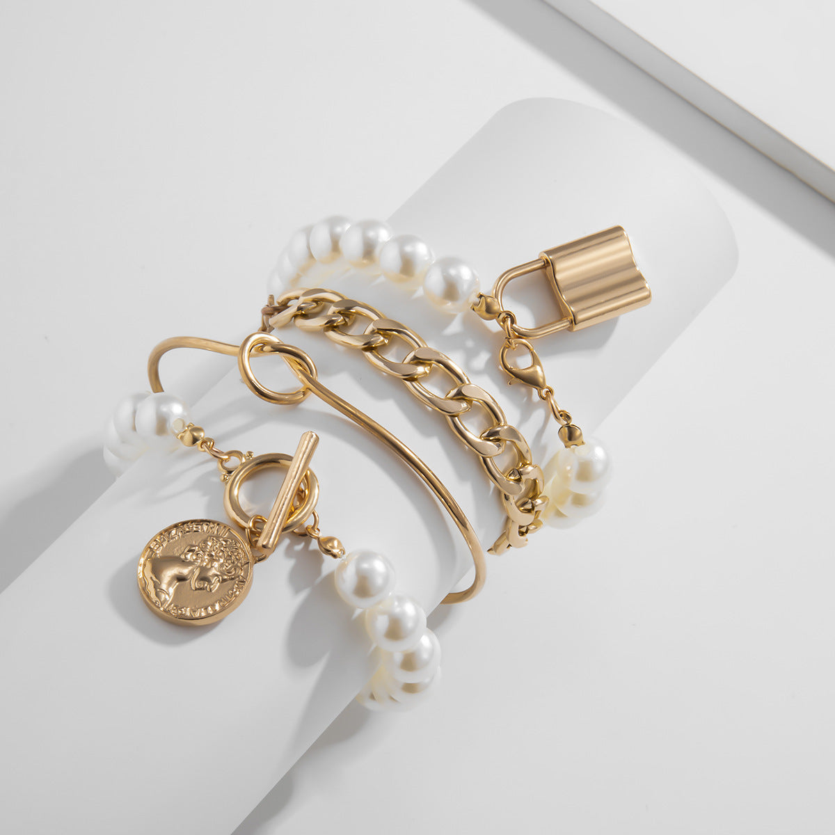 Gold bracelet with charms from ramodo jewelry store on a white surface