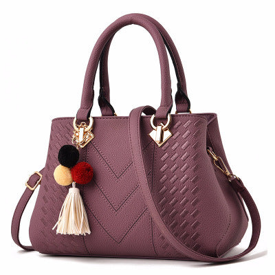 Chic and Versatile Woven Handbag with Tassel Charm