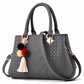 Chic and Versatile Woven Handbag with Tassel Charm