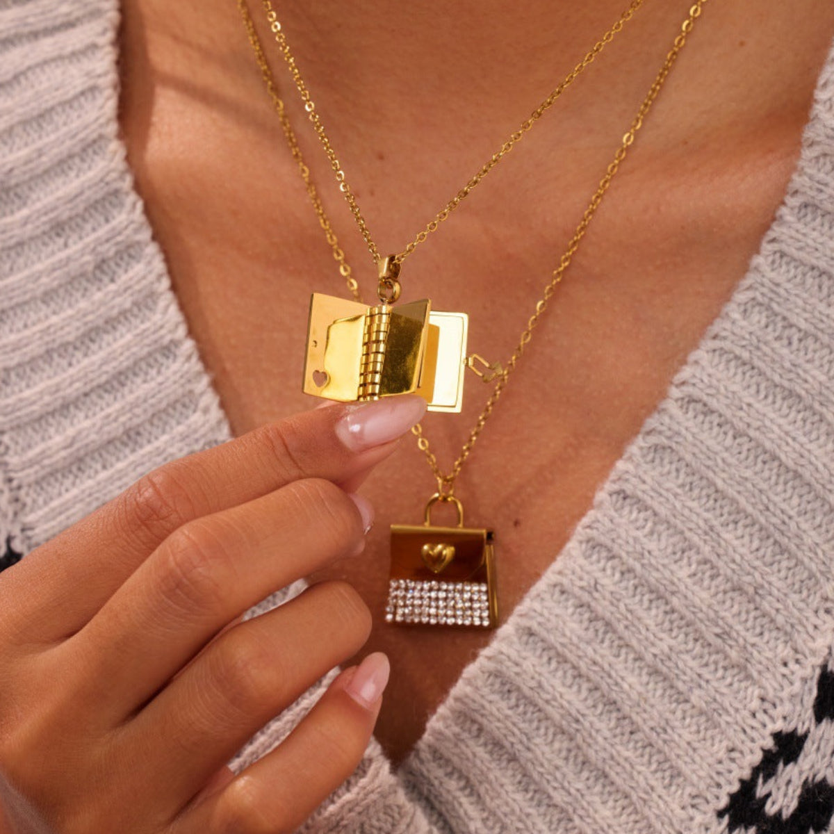 Gold necklace with book-shaped pendants worn by a person
