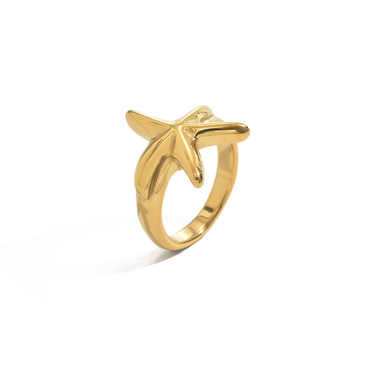Gold starfish ring on a white background
