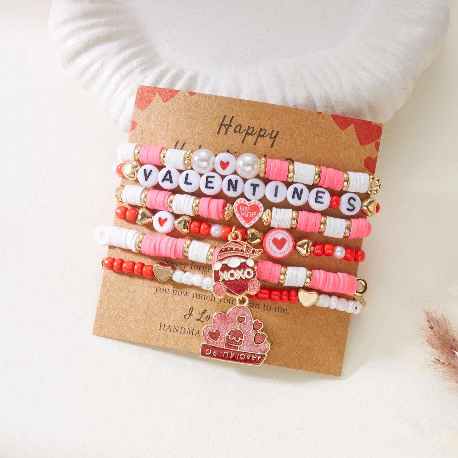 Set of colorful bracelets on a brown card with 'Happy Valentine's' text