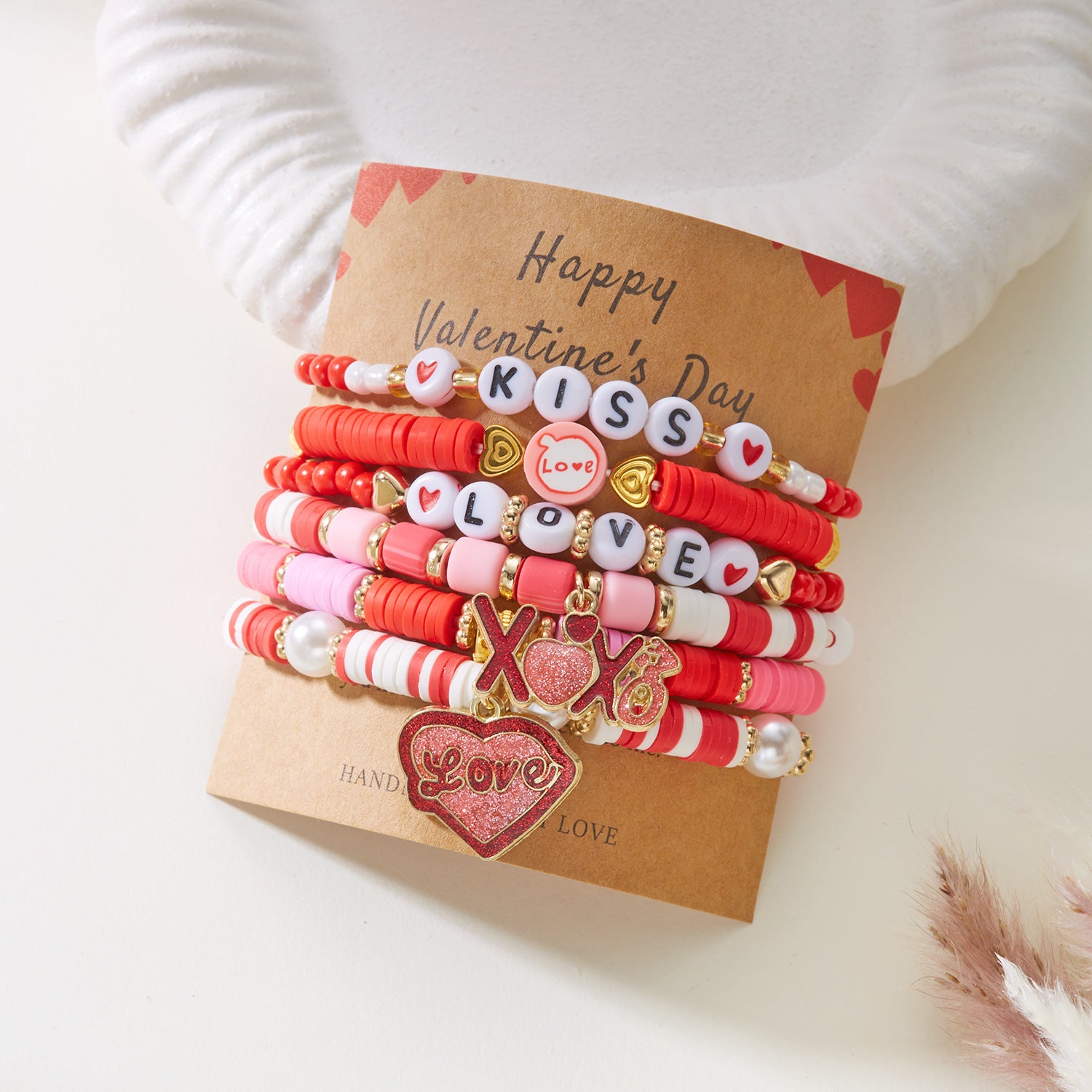 Set of Valentine's Day-themed bracelets on a brown card with 'Happy Valentine's Day' text.