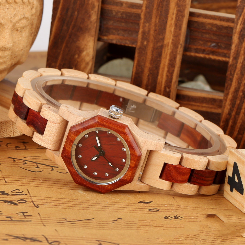 Wooden watch with a red face on a wooden surface