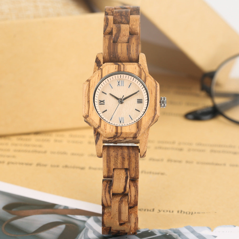 Wooden wristwatch on a surface with a blurred background