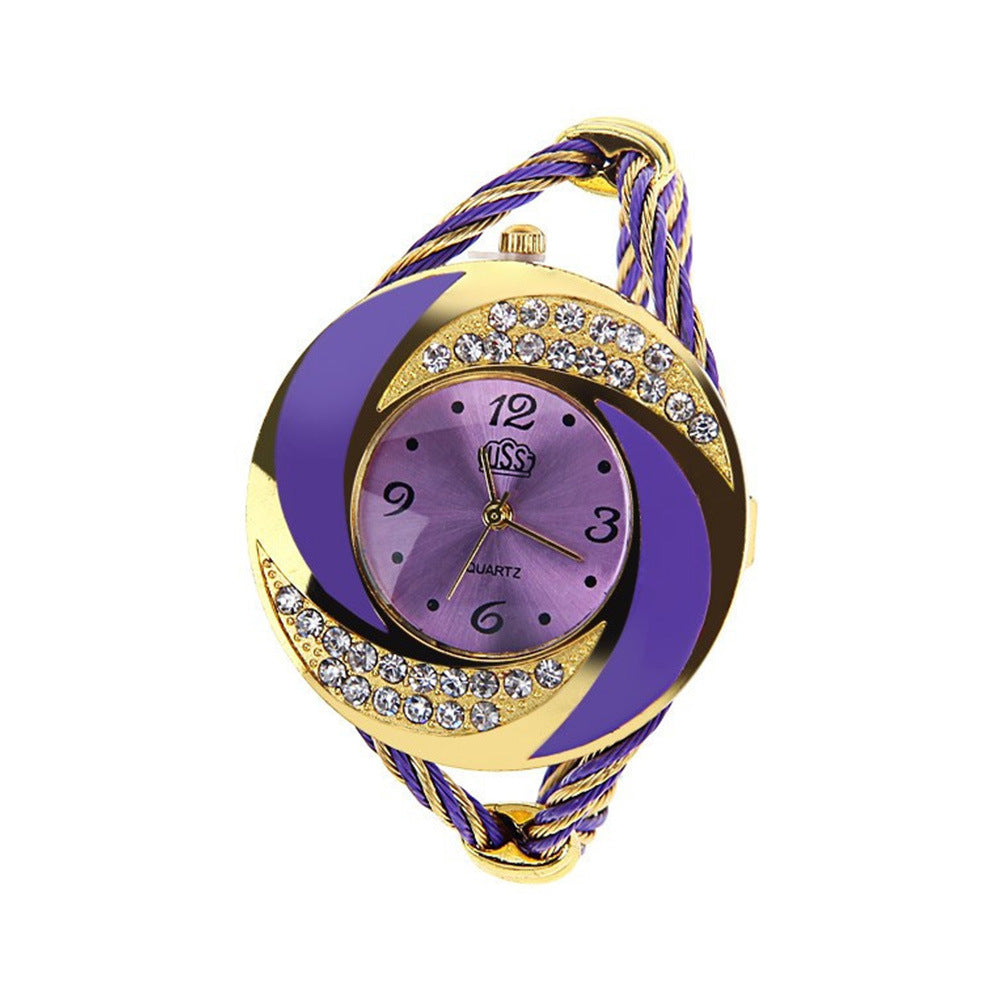 Purple and gold watch with braided strap on a white background