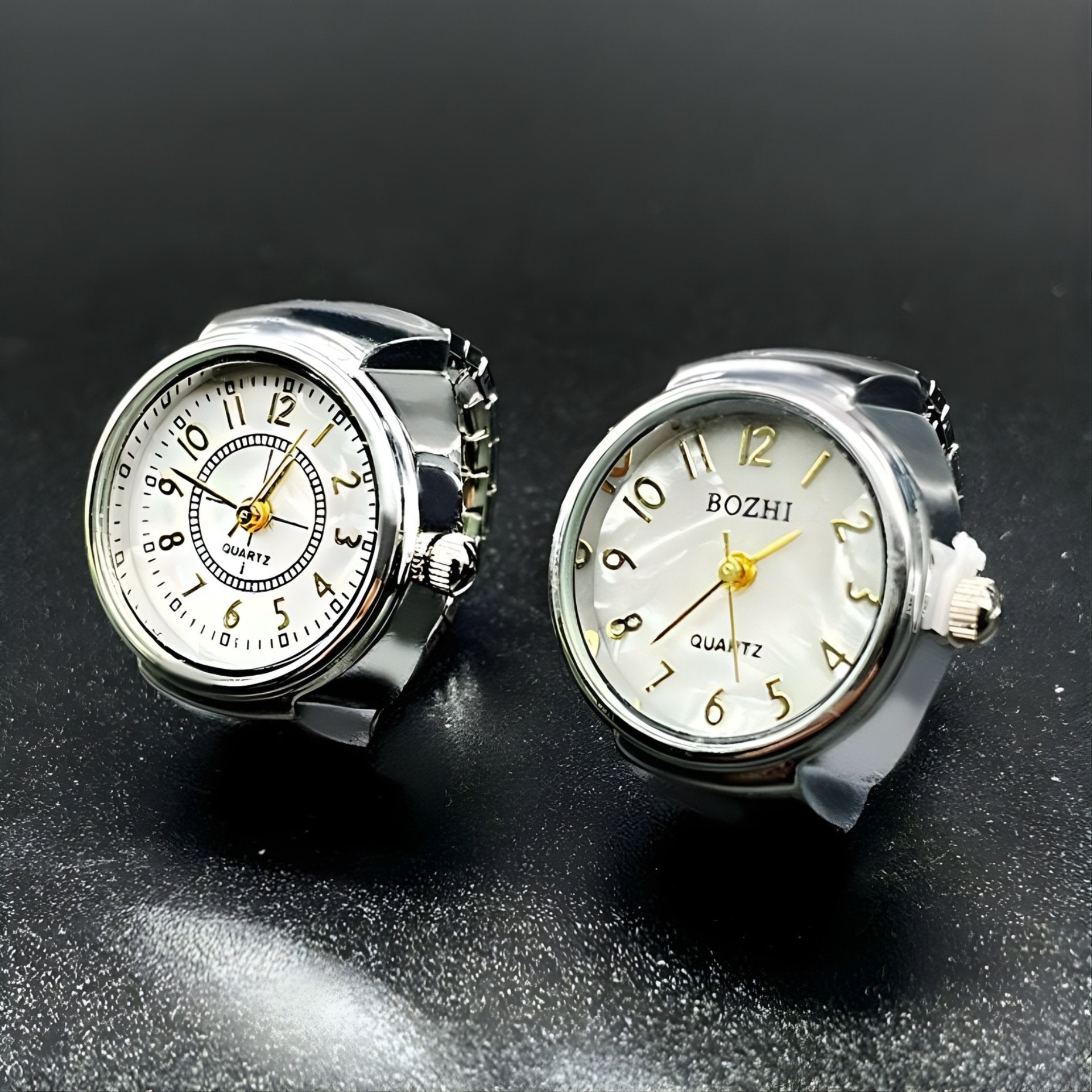 A collection of two ring watches with sparkling crystals, displayed in silver colors.