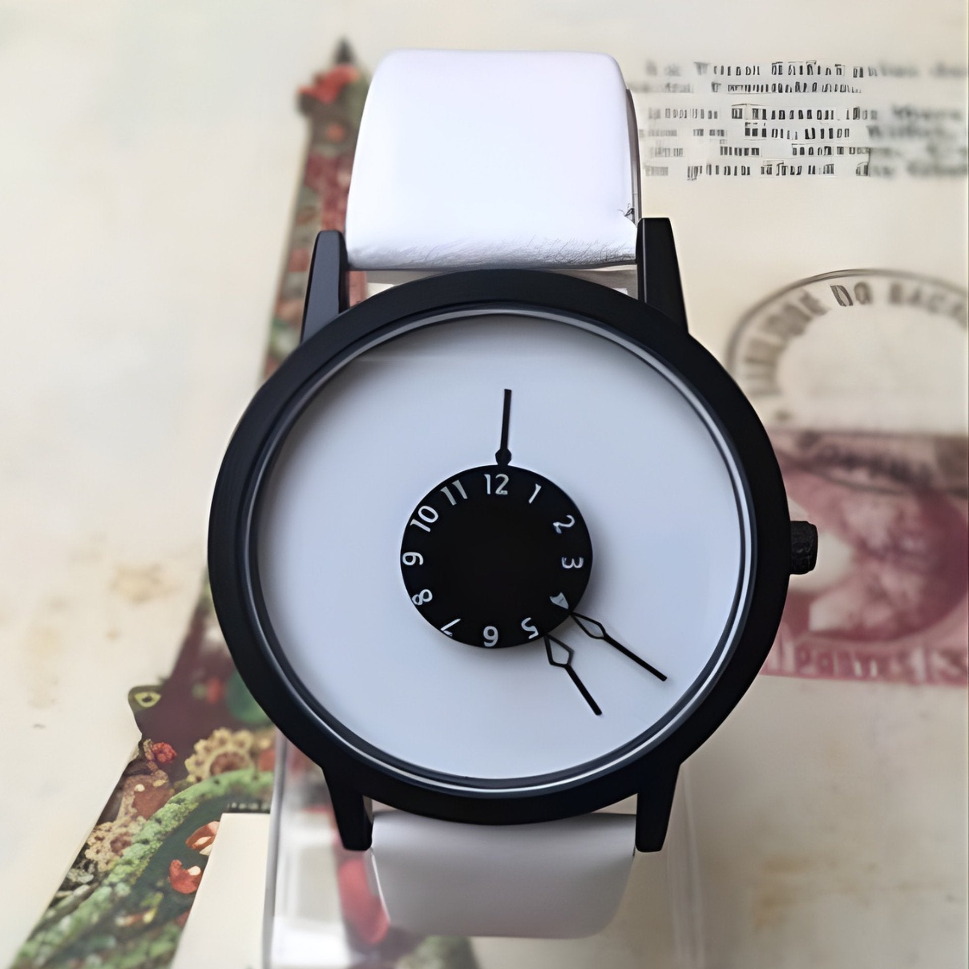 White watch with black face on a vintage-style background