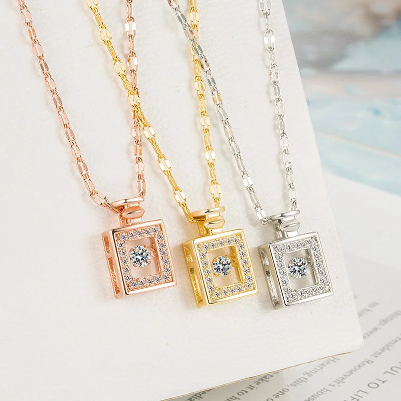 Three square pendant necklaces in rose gold, gold, and silver on a light background.