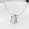 Silver necklace with a square pendant on a white background