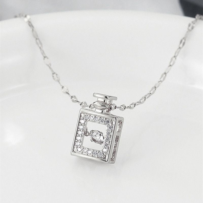 Silver necklace with a square pendant on a white background