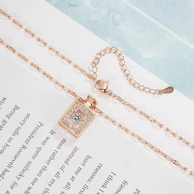 Rose gold necklace with a square pendant on an open book