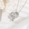 Silver heart-shaped necklace with rose design on a white background