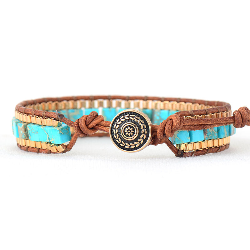 Bracelet with turquoise stones and brown leather strap on a white background