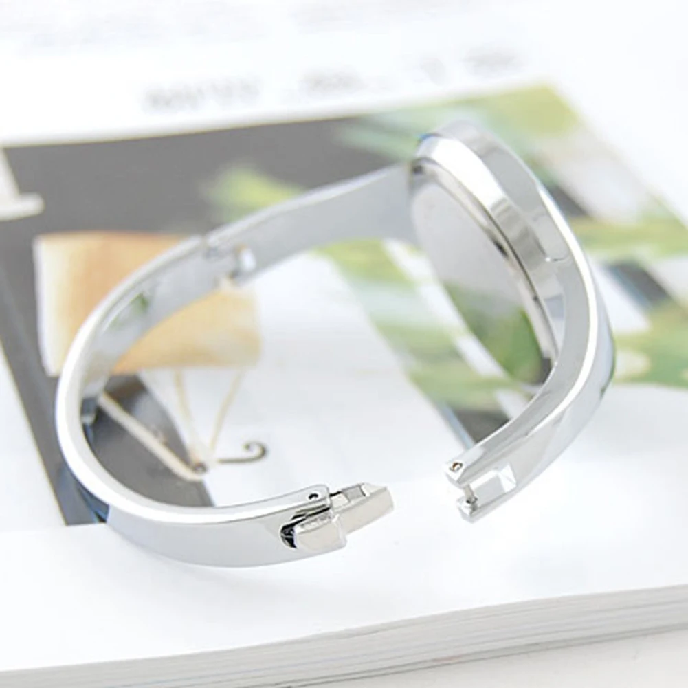 Silver ring with a reflective surface on a magazine background