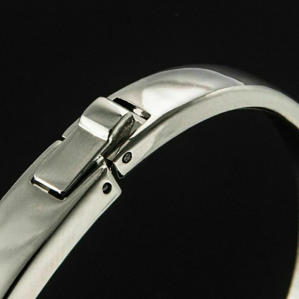 Close-up of a silver bracelet on a black background