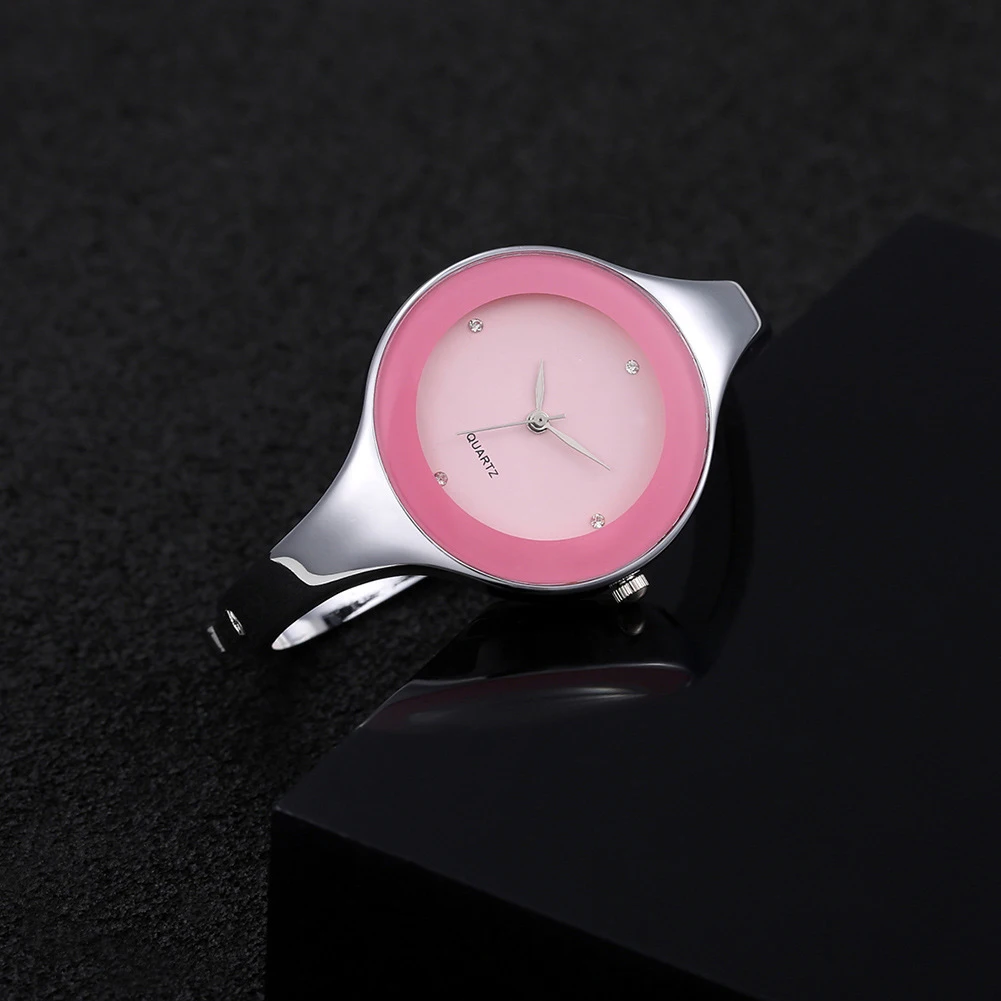 Pink watch with silver case on a black background