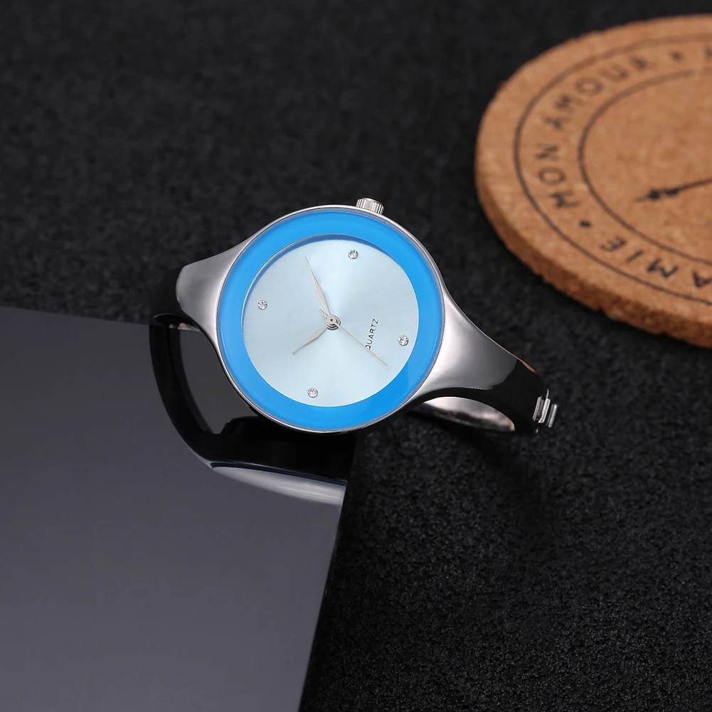 Wristwatch with blue and silver design on a dark textured background