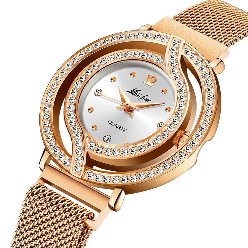 Rose gold watch with diamond-studded bezel on a white background
