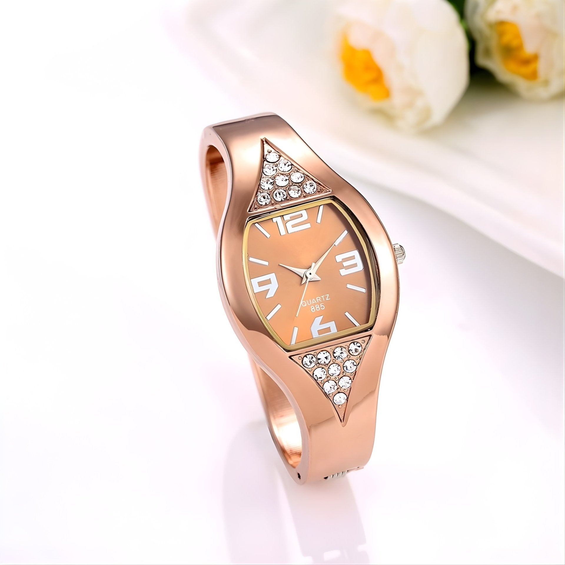 Rose gold watch with diamond accents on a white background