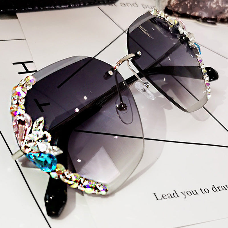 High-fashion Celestial Glow rimless diamond butterfly sunglasses in grey color with crystal-embellished lenses.