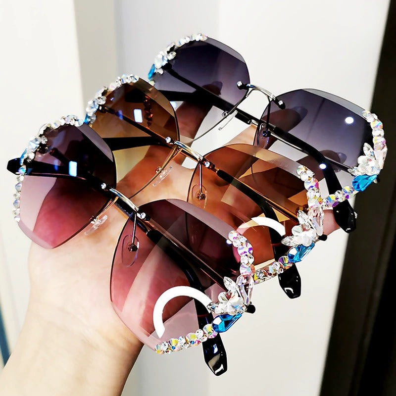 High-fashion collection of Celestial Glow rimless diamond butterfly sunglasses in brown, pink, purple, and grey jelly colors with crystal-embellished lenses.