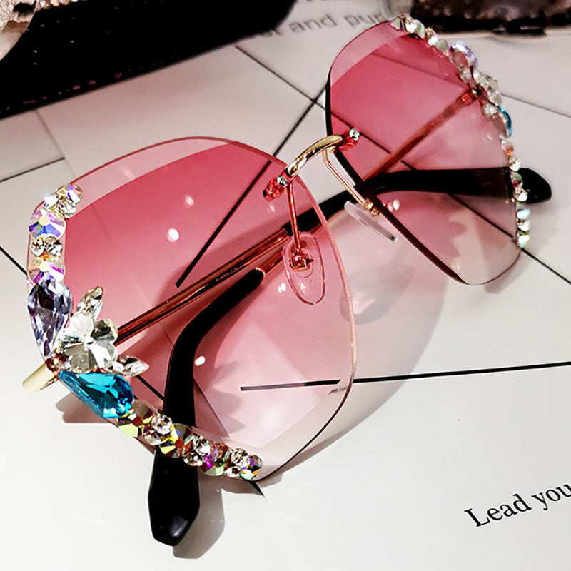 High-fashion Celestial Glow rimless diamond butterfly sunglasses in pink color with crystal-embellished lenses.