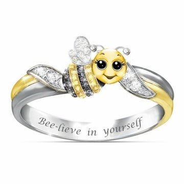 Bee-themed ring with 'Bee-lieve in yourself' engraving on a white background