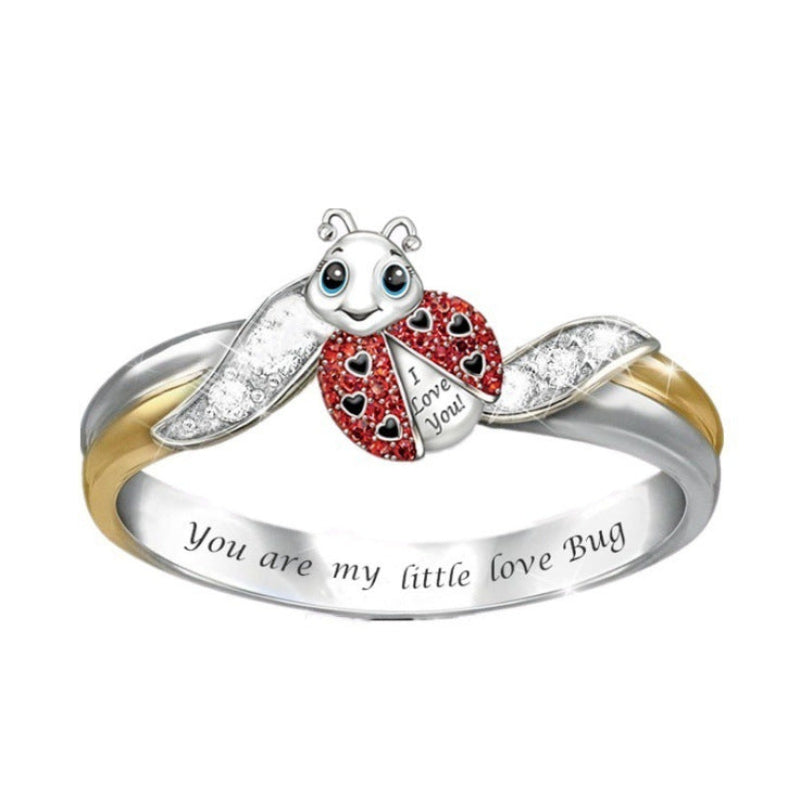 Silver and gold ladybug ring with 'I Love You' and 'You are my little love bug' text on a white background