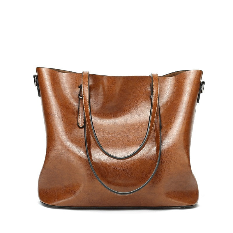 Brown leather tote bag on a white background