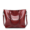 Red handbag with a strap on a white background