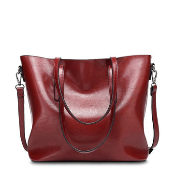 Red handbag with a strap on a white background