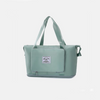 A sage green tote bag on a light gray 