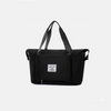Black tote bag on a light gray 