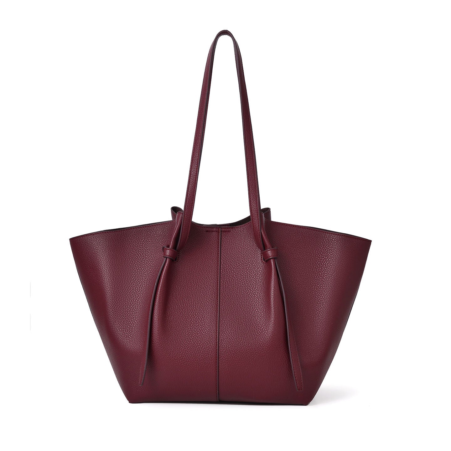 A burgundy pebbled leather tote bag with long shoulder straps and tie details, shown against a plain white background.