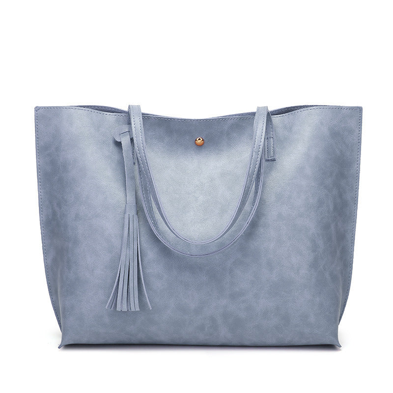 Sky blue tote bag with tassel on a white background