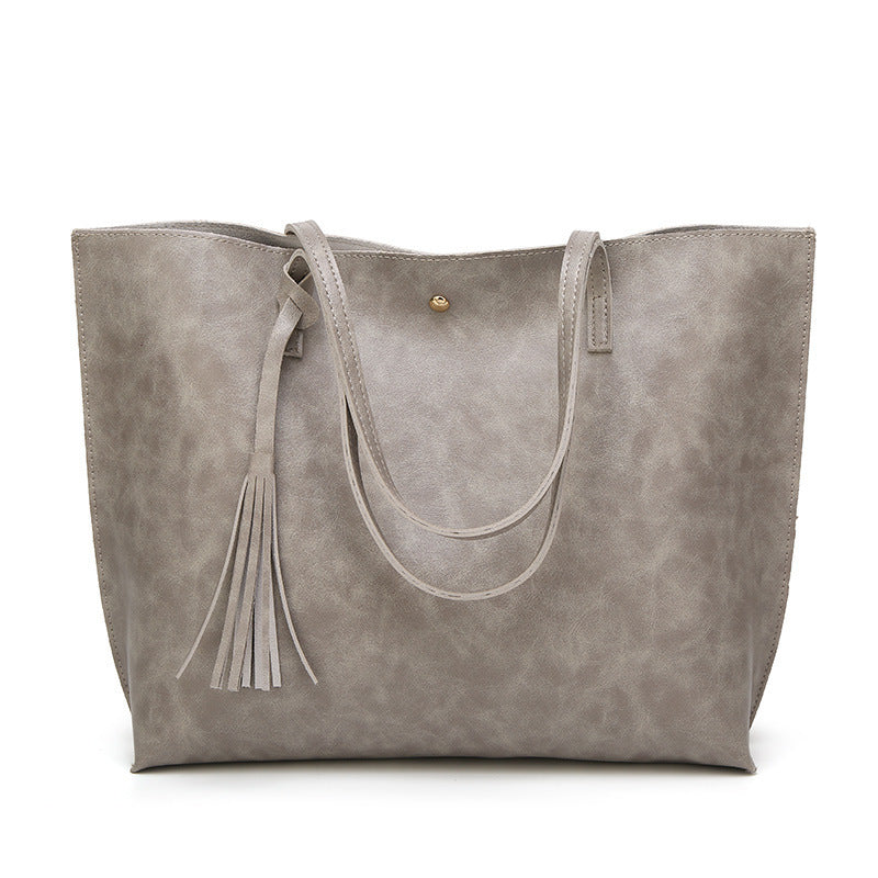 Gray tote bag with tassel on a white background